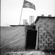 The flag of thePKK leader, Abdullah Ocalan at the entrance of a house. IDP camp in Ashti was divided into three areas: Kurdish, Arab, Yazida